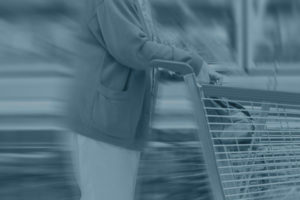 consumer pushing cart through grocery store